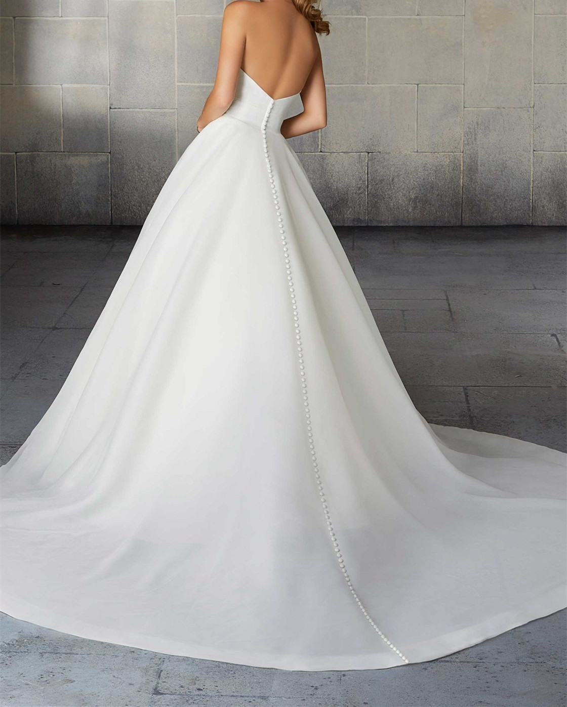 Organdy A-line silhouette with full ball gown overlay and a sheer train accented with horsehair trim.