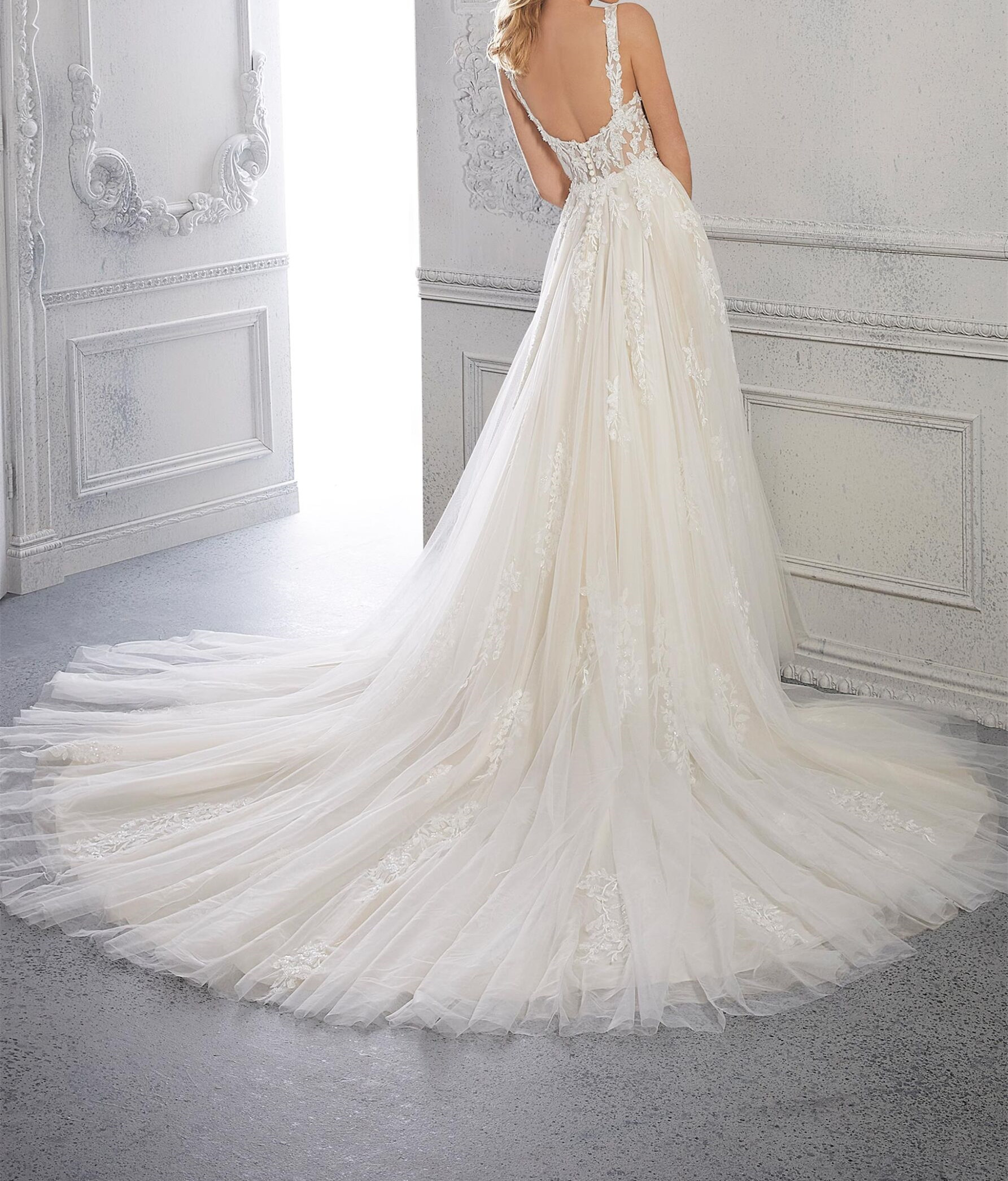 A-line, tulle wedding dress features a square neckline and embroidered straps