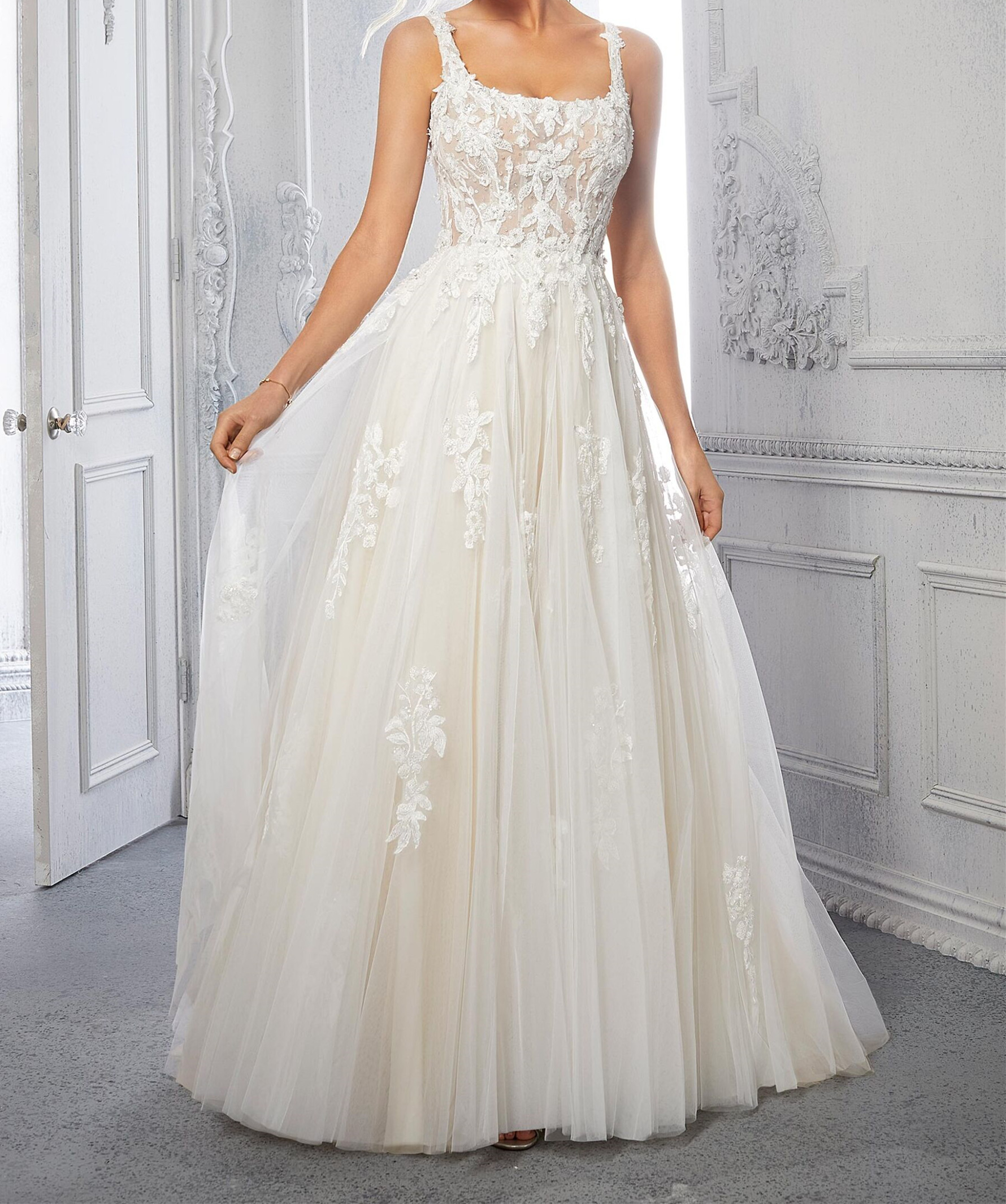 A-line, tulle wedding dress features a square neckline and embroidered straps