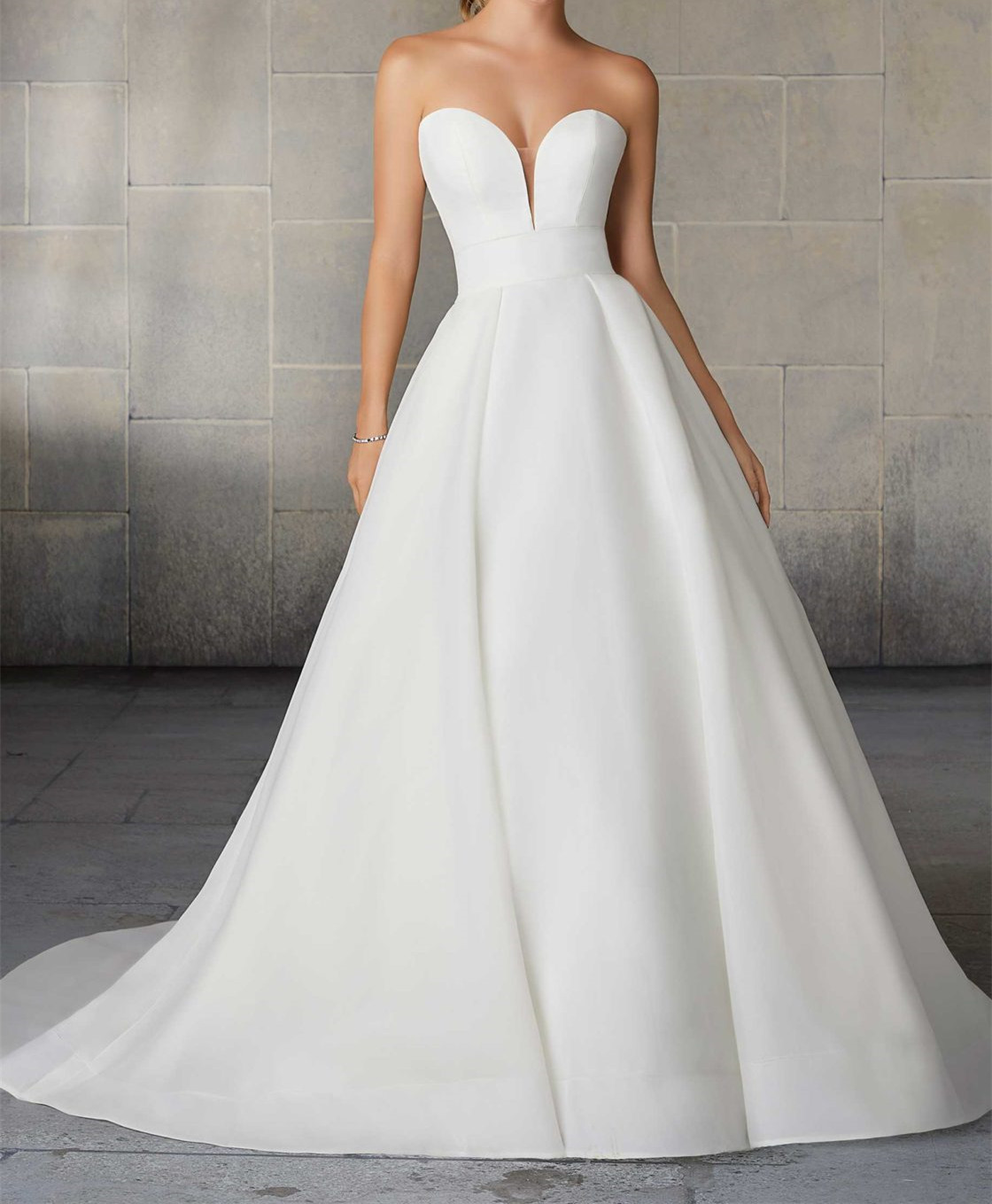 Organdy A-line silhouette with full ball gown overlay and a sheer train accented with horsehair trim.