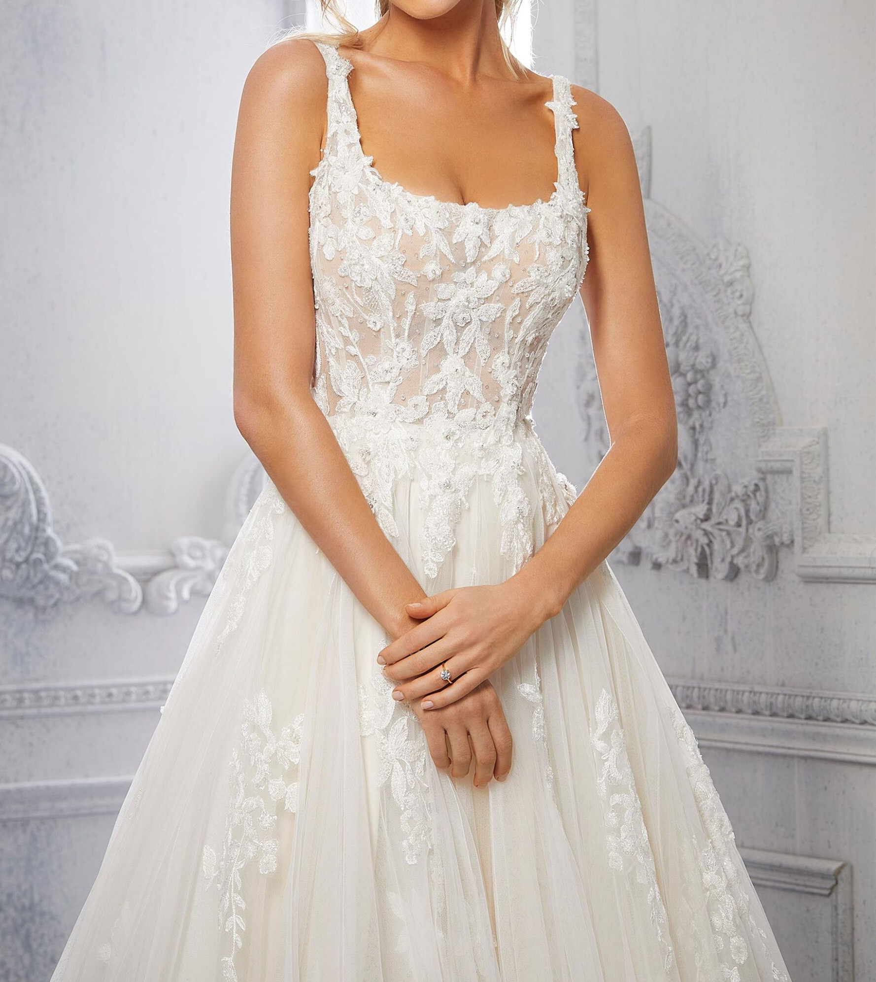 A-line, tulle wedding dress features a square neckline and embroidered straps